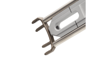 Close-up of a metallic surgical tool with four prongs and a central opening, designed for precise medical procedures.