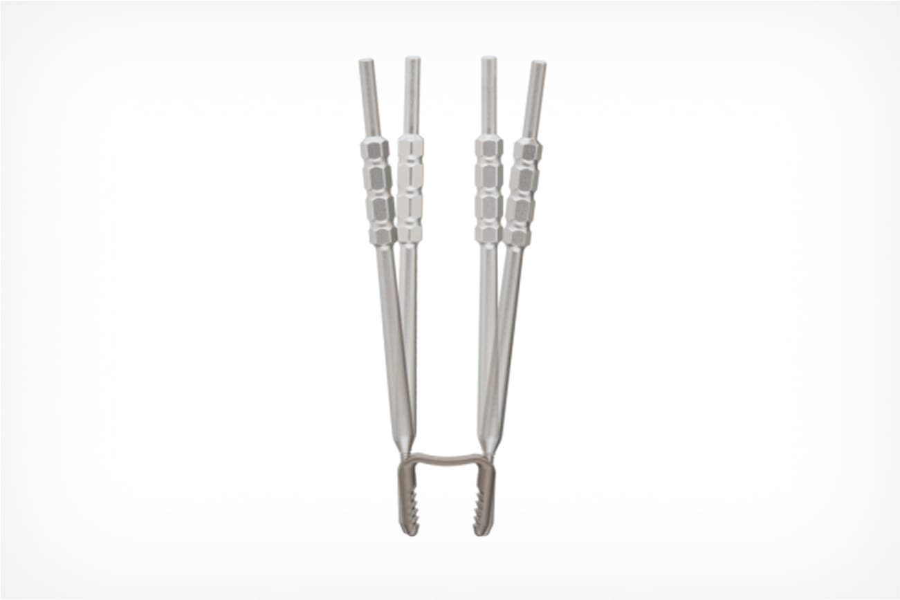Close-up of a metal instrument with serrated jaws and hexagonal handles against white background.