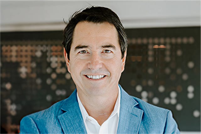 Professional headshot of a Treace Medical Concepts executive in a blue blazer and white dress shirt.