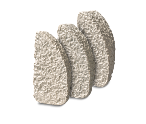 Three textured, curved stone sculptures standing upright against a plain white background.