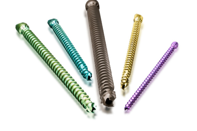 Colorful orthopedic screws arranged on a white background.