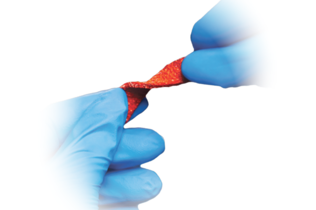 Gloved hands twisting a shiny, red twist-tie, focused in the center against a white background.